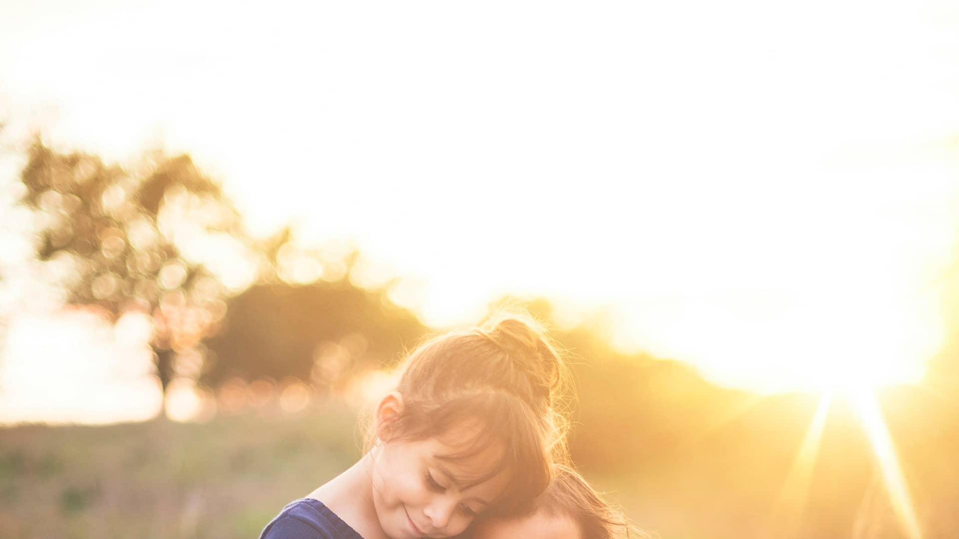 Two children reading together outdoors in warm afternoon light, seeing clearly without glasses